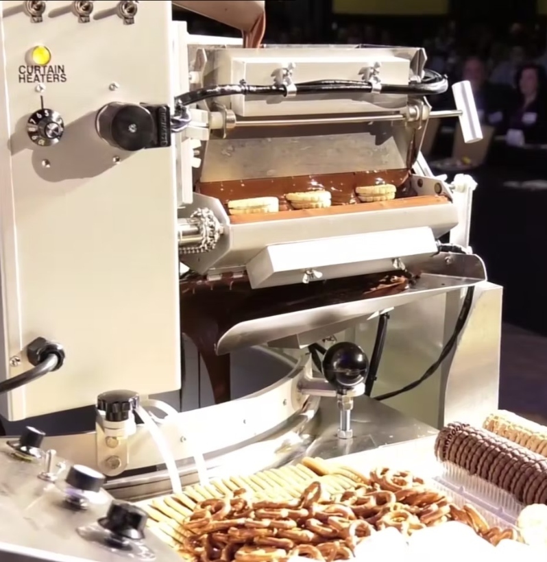 Product Description: Laurent Besin, Director Of Technical Services, Barry Callebaut. Presented at the 2018 conference</br></br>When enrobing, the physical attributes of any chocolate or coating are critical to achieving your goal.This presentation will address rheology, fineness, fat content, temperature and center makeup as it applies to actual enrobing. We will consider how these parameters affect the function of the product in an enrober, influence the center and the final result. We will also speak to the impact of each adjustment and how small changes will influence the coating of your product. Final wrap-up will include some troubleshooting tips for creating the perfect product for your customer.</br> 2018- Enrobing - Video